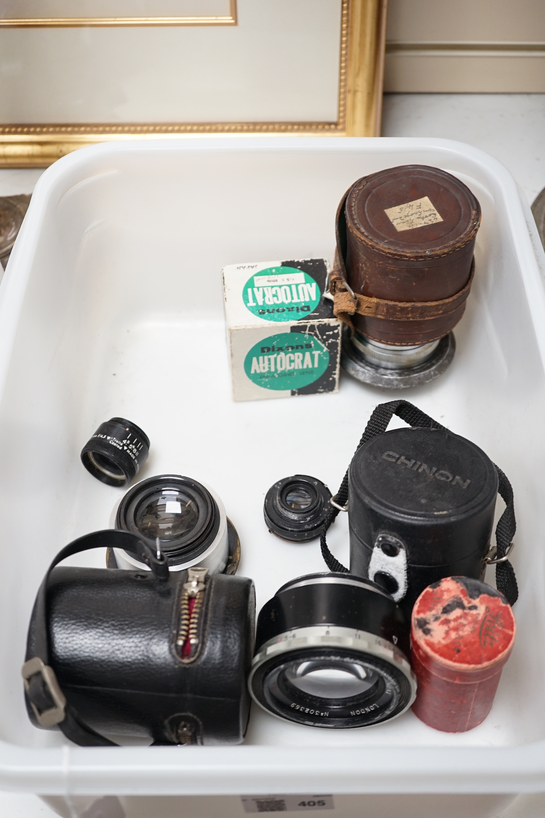 A collection of lenses for still cameras, including examples by Schneider-Kreuznach, Wray, Aldis, Tamron, etc.